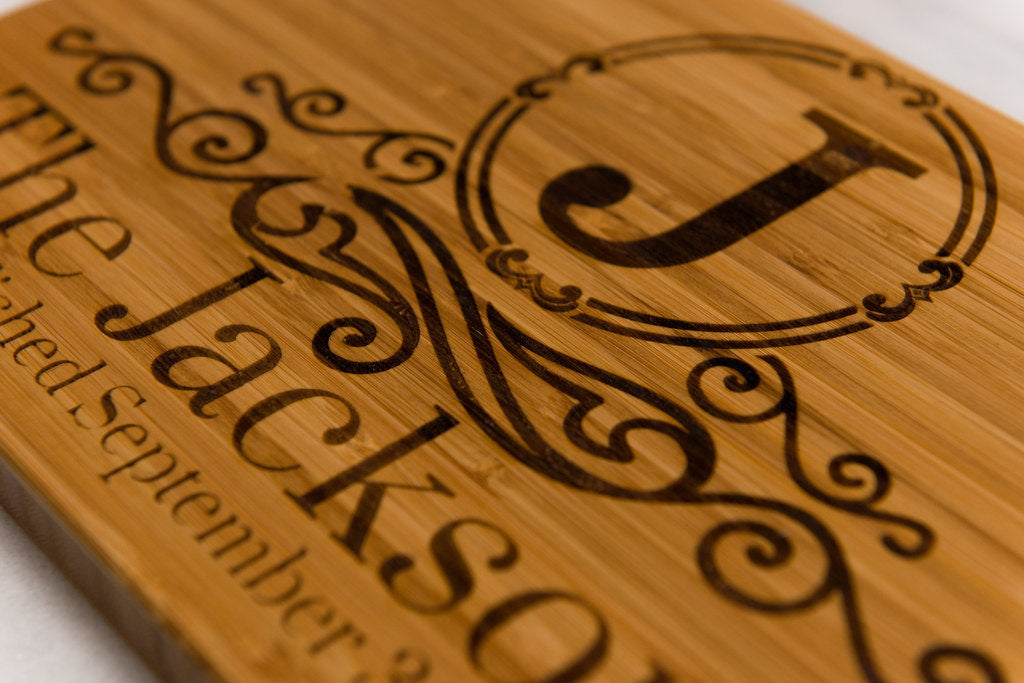 Close-up of monogram on Family Name Monogrammed Bamboo Cutting Board