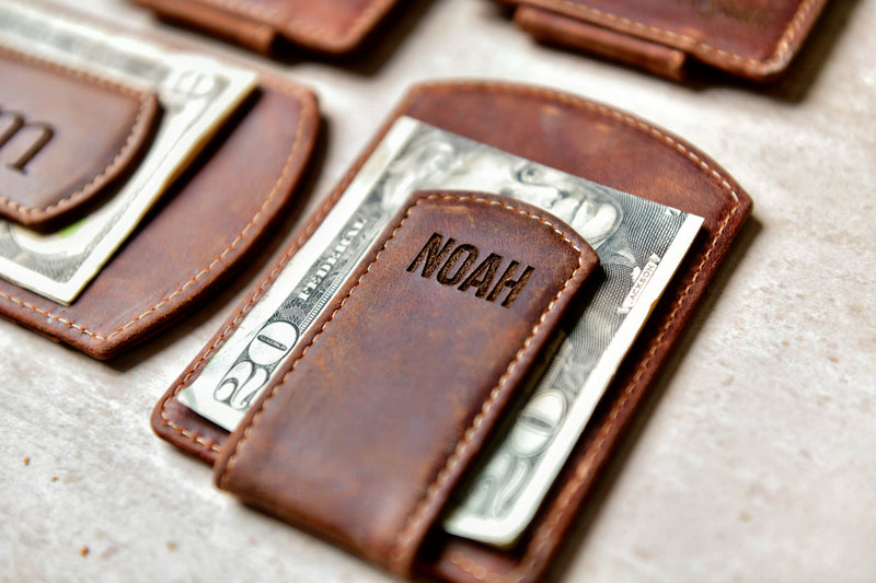 Close-up of the Super Slim Personalized Leather Magnetic Money Clip with money under engraved clip