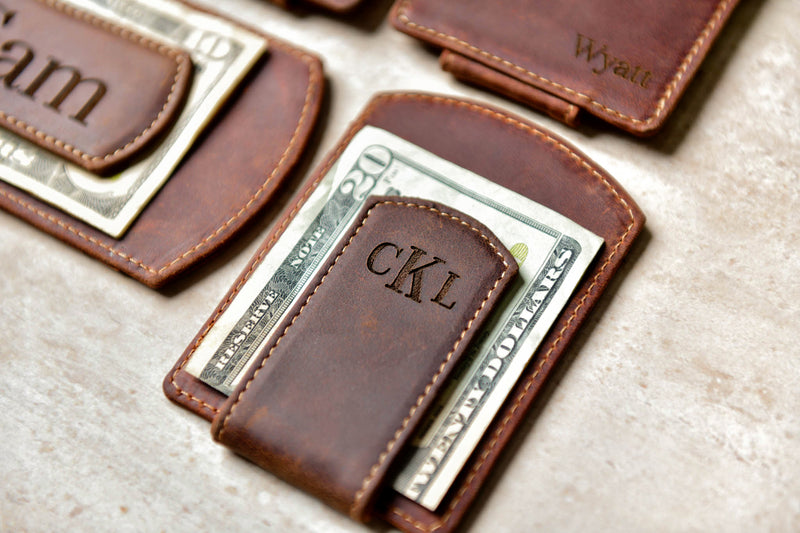 Close-up of the Super Slim Personalized Leather Magnetic Money Clip holding twenty dollars