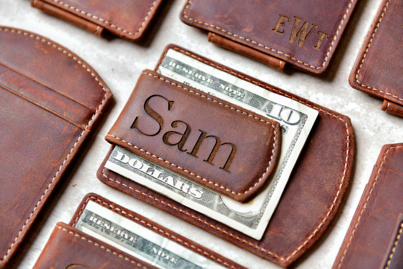 Super Slim Personalized Leather Magnetic Money Clip holding 10 dollars. The name “Sam” is engraved on the clip.