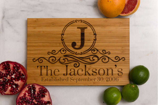 Family Name Monogrammed Bamboo Cutting Board surrounded by fruit